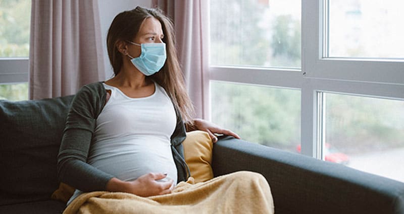 Pregnant woman in face mask