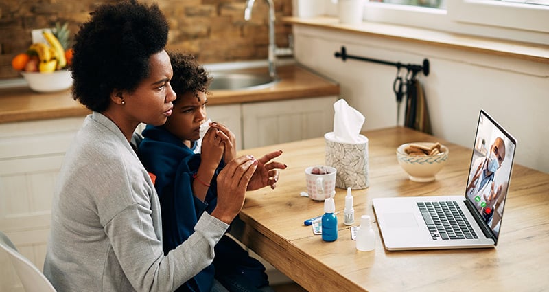 mom and child having video visit with provider