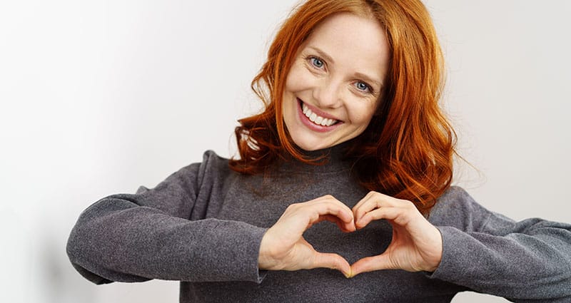 happy woman making heart with hands