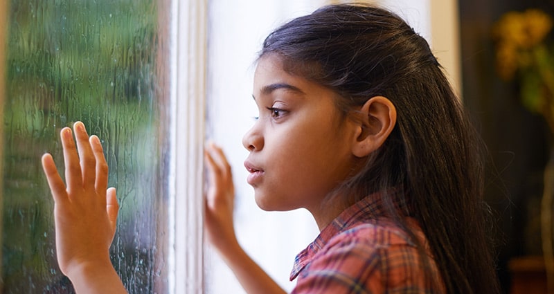 Child looking out window