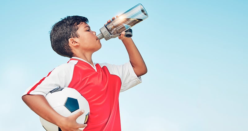 young athlete drinking water