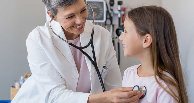 child speaking with doctor