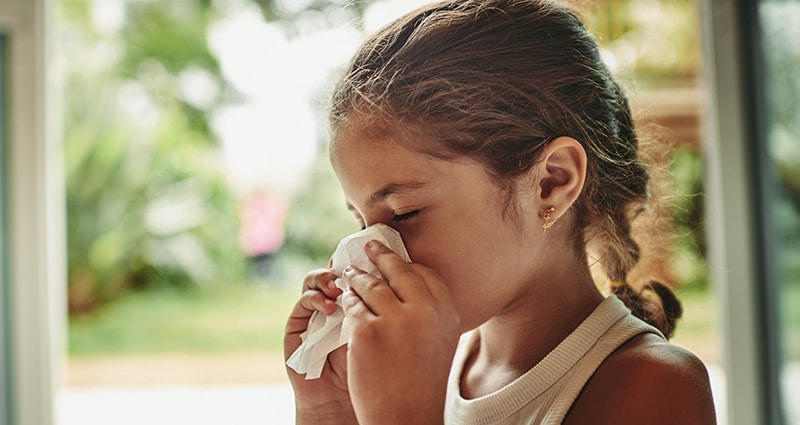 girl blowing her nose