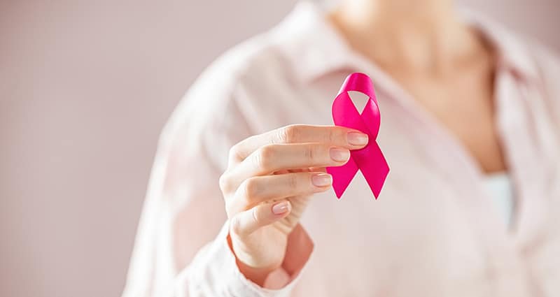 woman holding pink ribbon