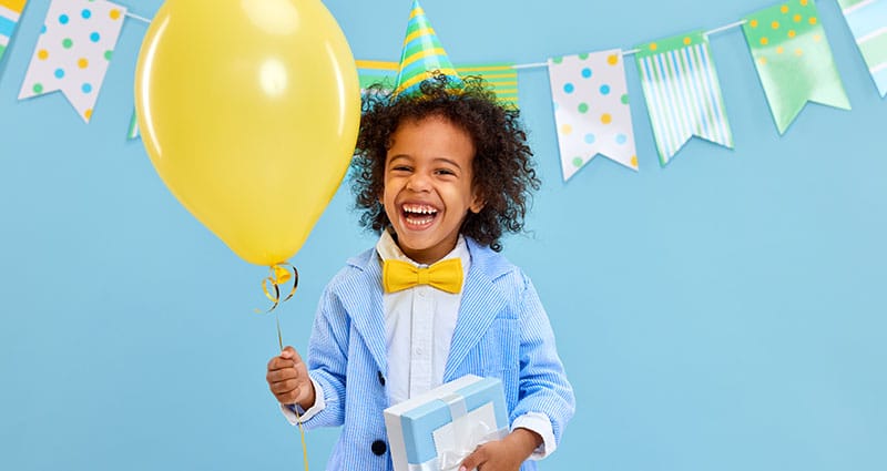 happy child holding birthday baloon