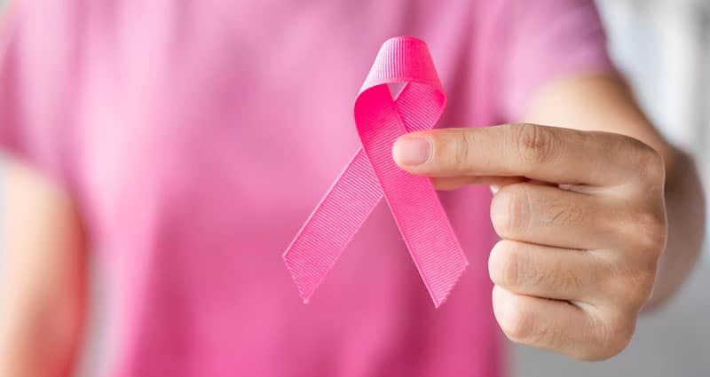 hand holding breast cancer ribbon