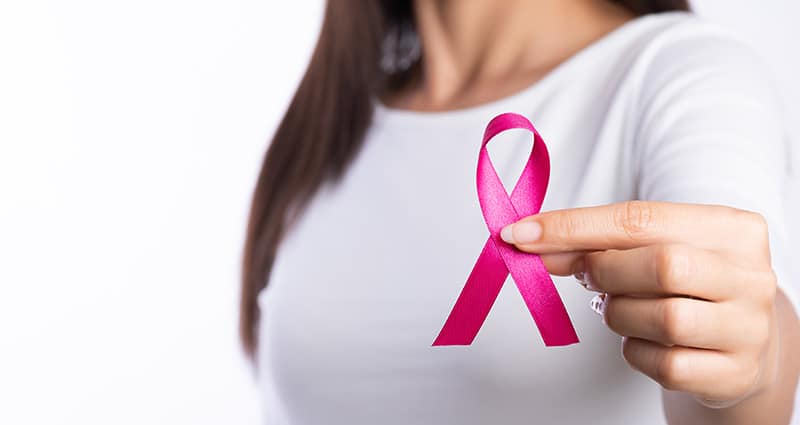 woman holding pink ribbon