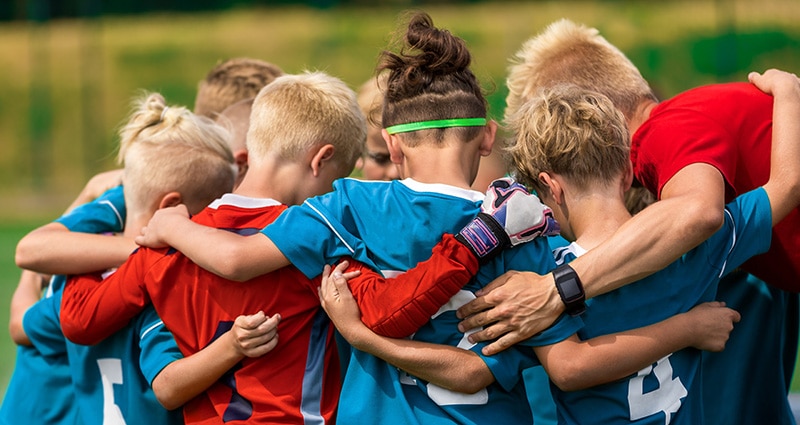 young athletes huddling