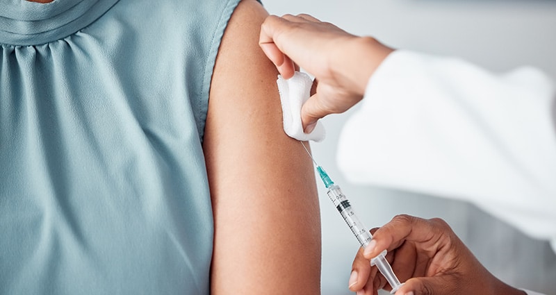 person receiving flu shot in arm