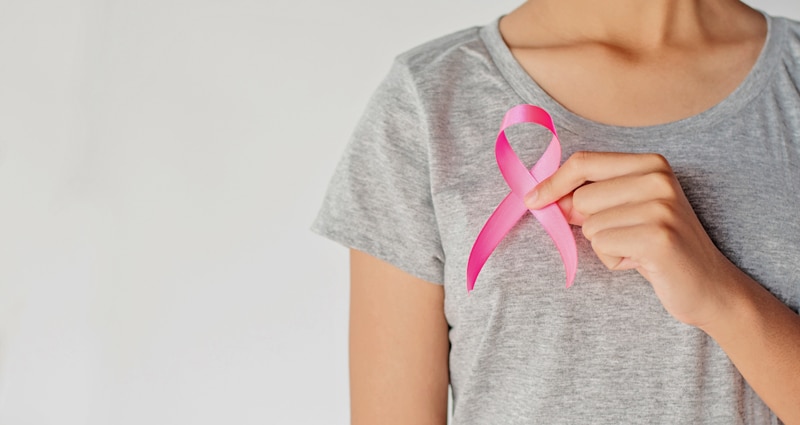 woman holding breast cancer ribbon