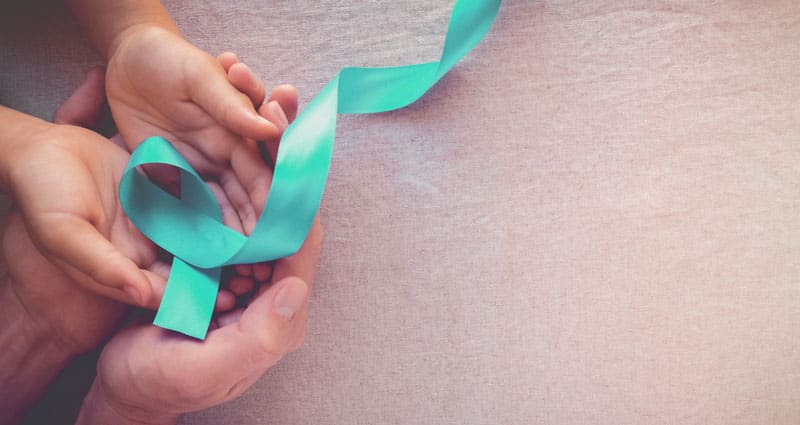 hands holding a green ribbon