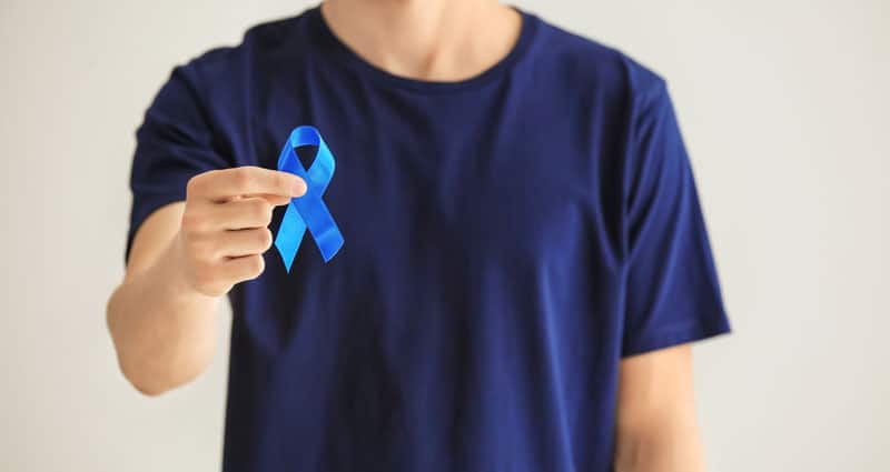 adult man holding blue ribbon