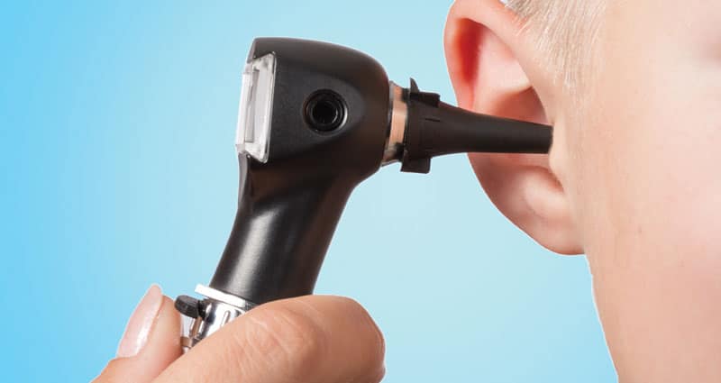 medical professional inspecting ear