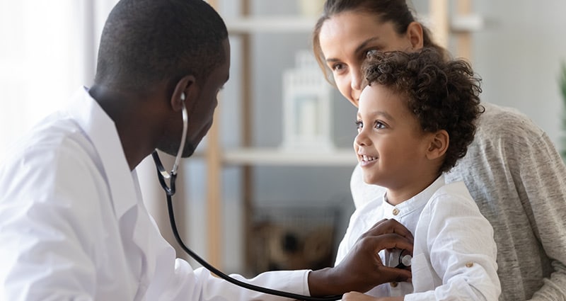 Doctor listening to a child's heartbeat with stethoscope