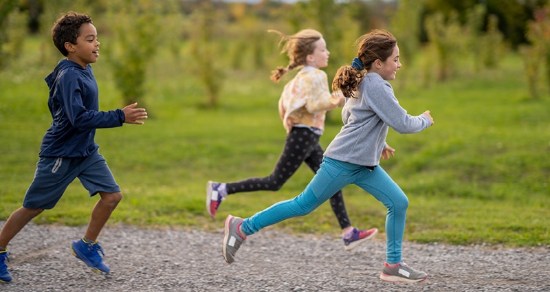 kids running on a gravel road