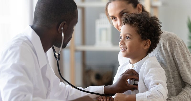 Doctor listening to a child's heartbeat with stethoscope