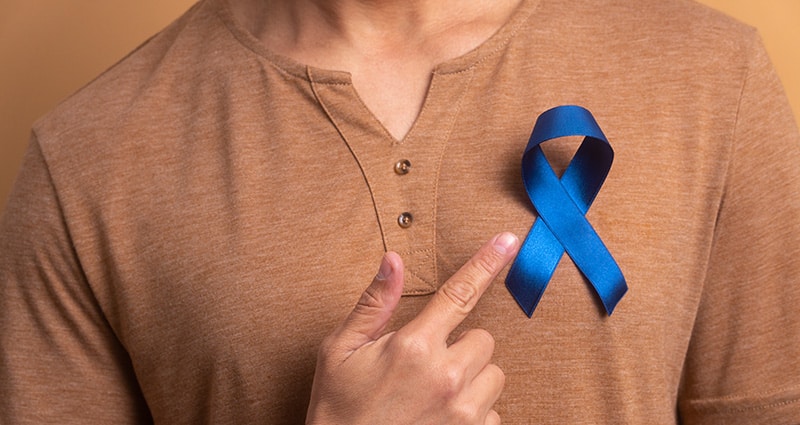 woman pointing to blue ribbon