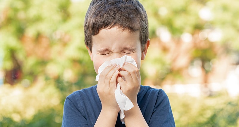 kid blowing his nose