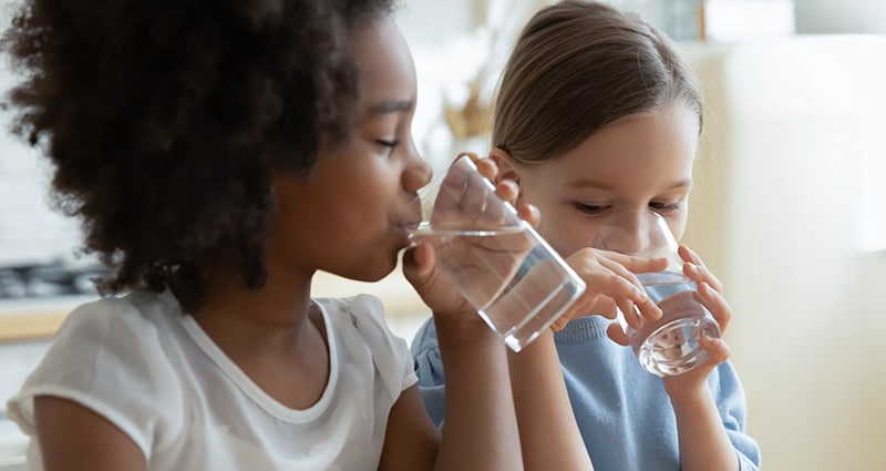 girls drinking glasses of water