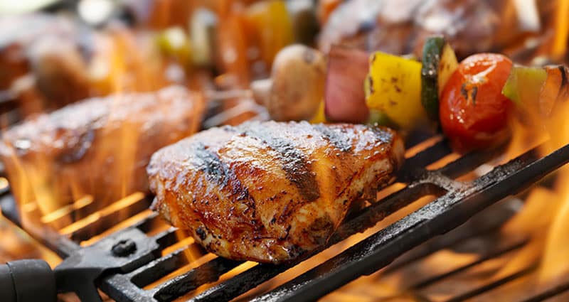 chicken and vegetables being cooked on grill