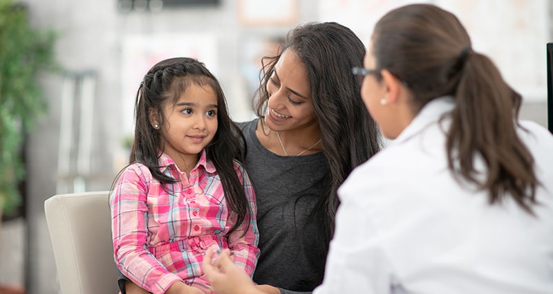 happy child interacting with medical provider