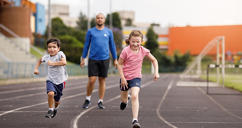 kids running on track with parent