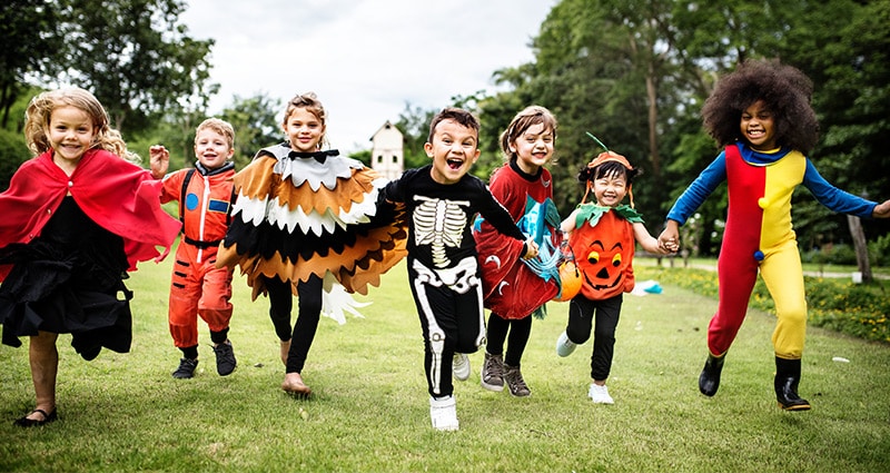 kids in costumes running toward camera