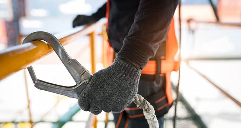 a worker holding a safety device
