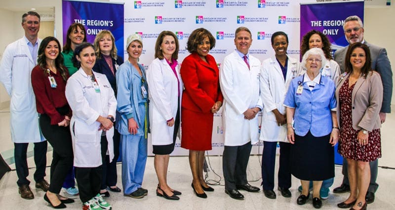 group photo featuring medical professionals standing indoors