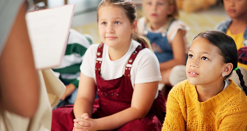 child listening to teacher in class