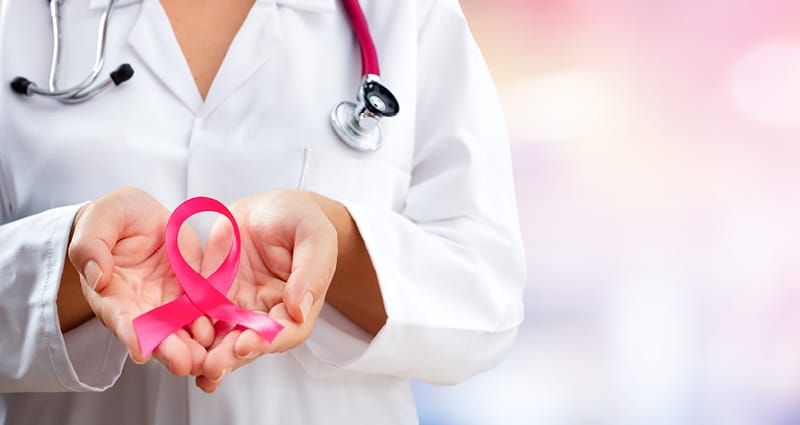 doctor holding pink ribbon