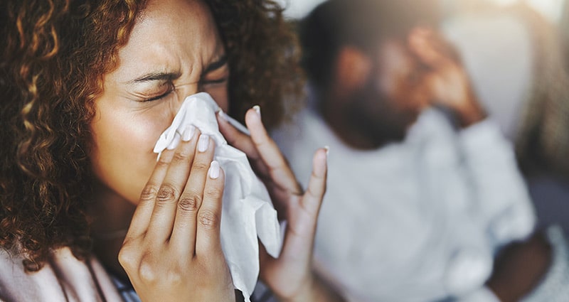 woman blowing her nose