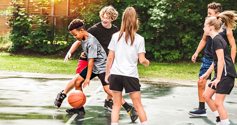 kids outdoors playing basketball