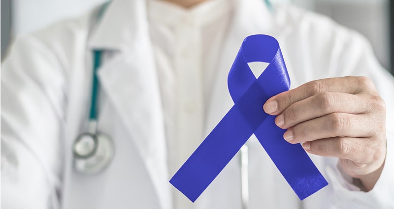 doctor holding blue ribbon