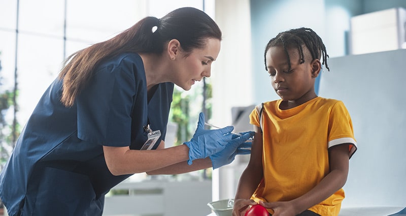 healthcare provider giving vaccine to child