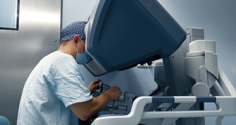 surgeon using robotic tool