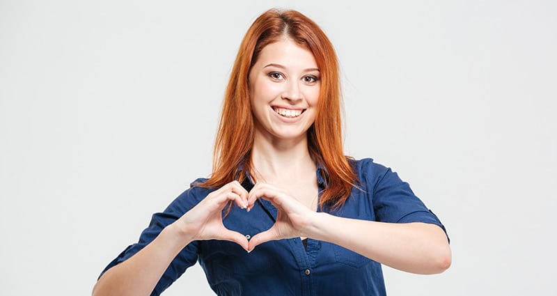 happy woman making heart with hands