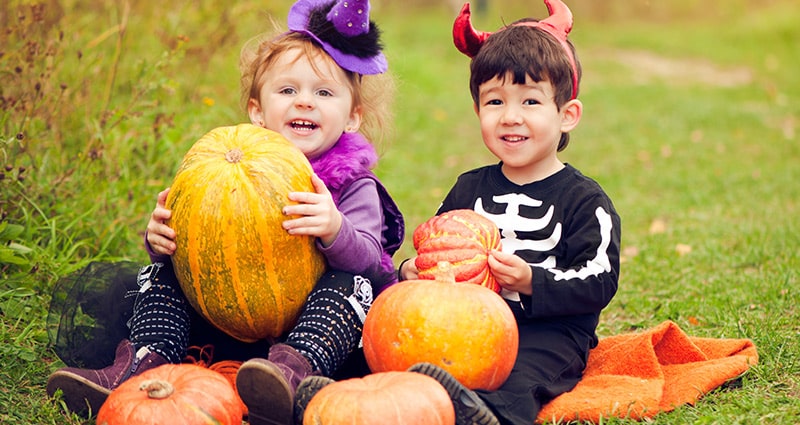kids in costumes with pumpkins