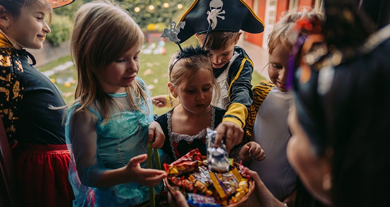kids in costumes choosing treats