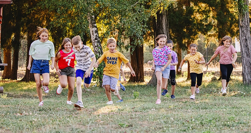 kids running toward camera at a summer camp