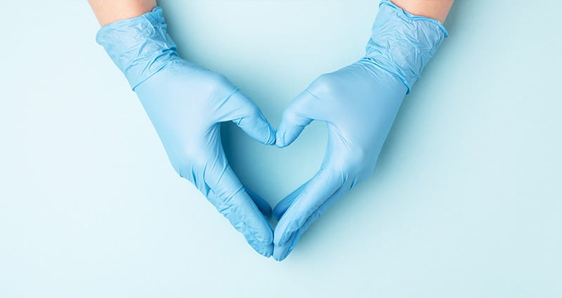 gloved hands in shape of heart